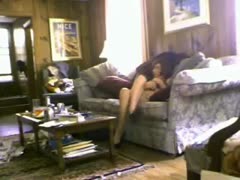 An elderly, slender, and filthy slut wife is seen masturbating in the living room.